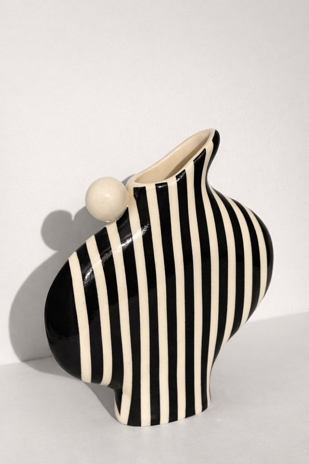 Black Striped Vessel With A Ball Handle